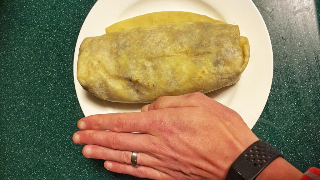 Javi's Tacos Carne Asada Burrito compared to human hand
