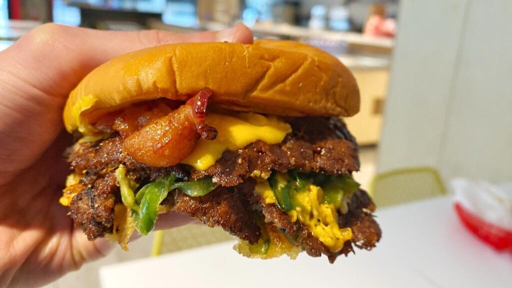 All American Burger Smokin' Hot Smash (in hand)