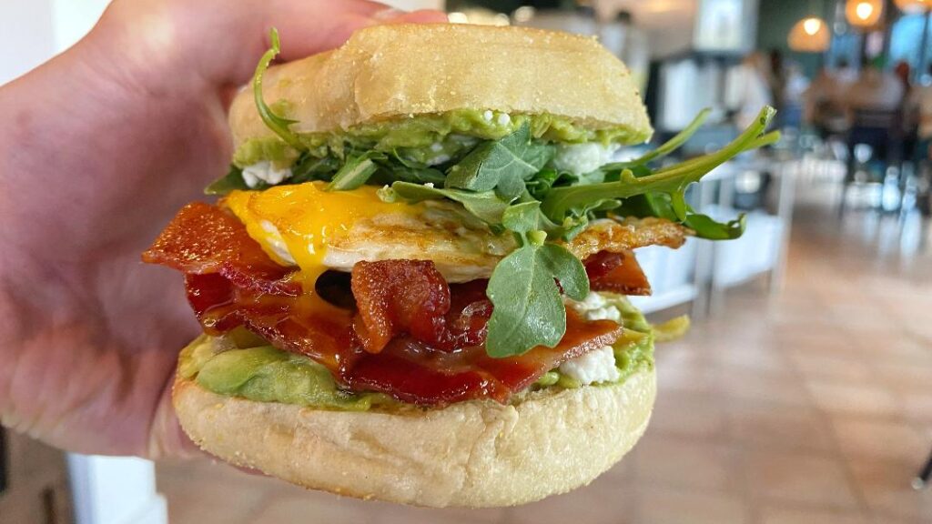 Good Lookin' Avocado Goat Cheese Breakfast Sandwich (in hand)