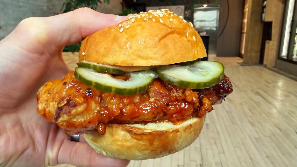 All In Thyme Hot Honey Buffalo Chicken Sandwich (in hand)