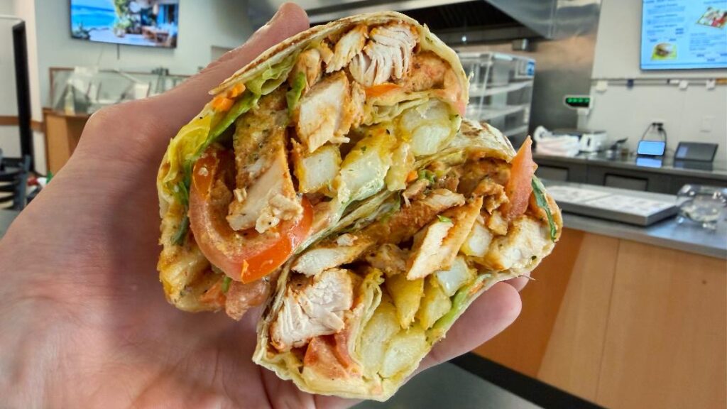 Legacy Gyros Chicken Wrap (in hand)