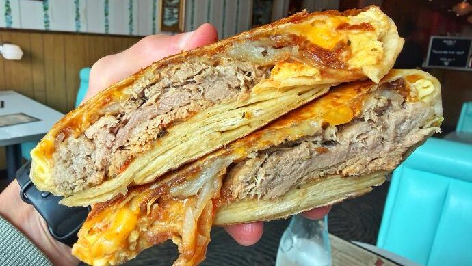 Fizzy's Fountain & Liquors Breakfast Crunchwrap (in hand)