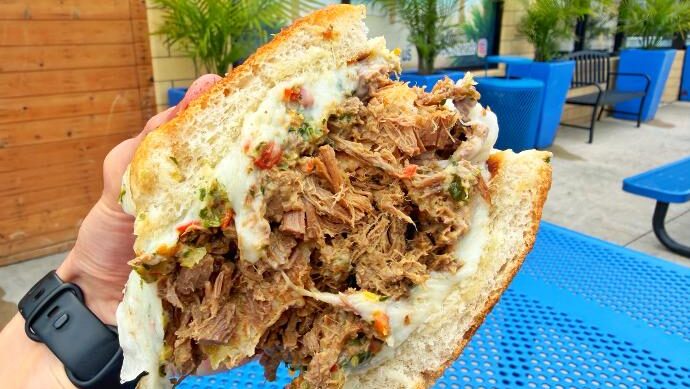 Latin Bites Cali Melt Sandwich (in hand)